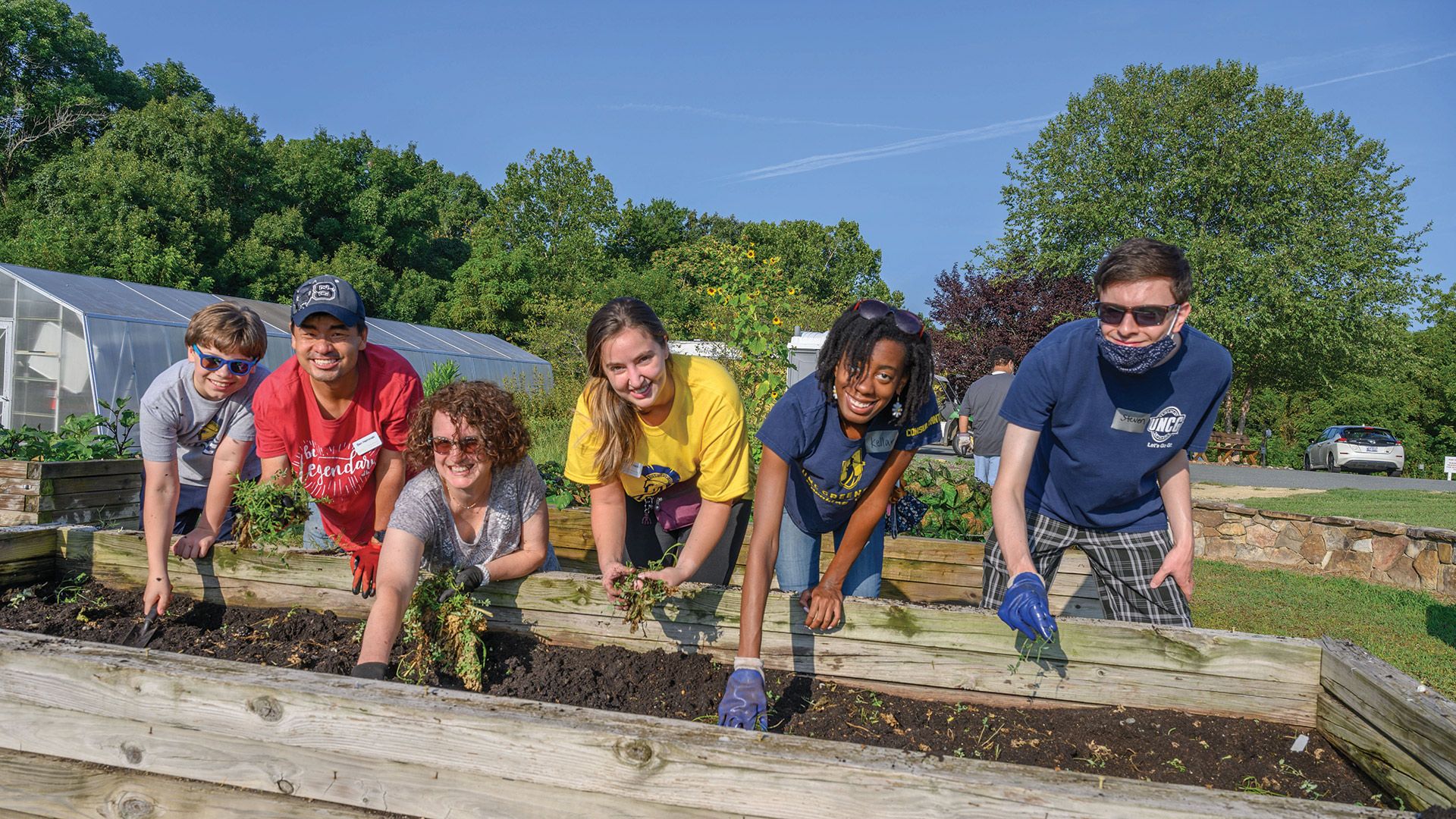 Professor Kim Cuny and students from UNCG's Speaking Center volunteer at Peacehaven Community Farm.