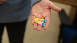 A close up of a hand holding blood samples.