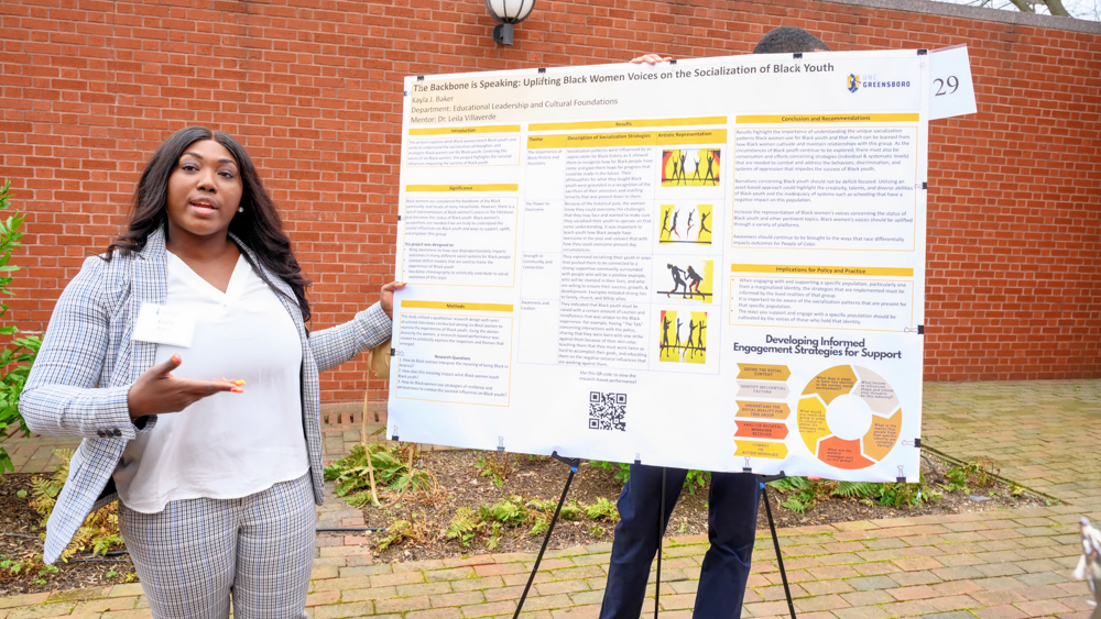 Kayla Baker presents her research poster at the Graduate Research and Creativity showcase.