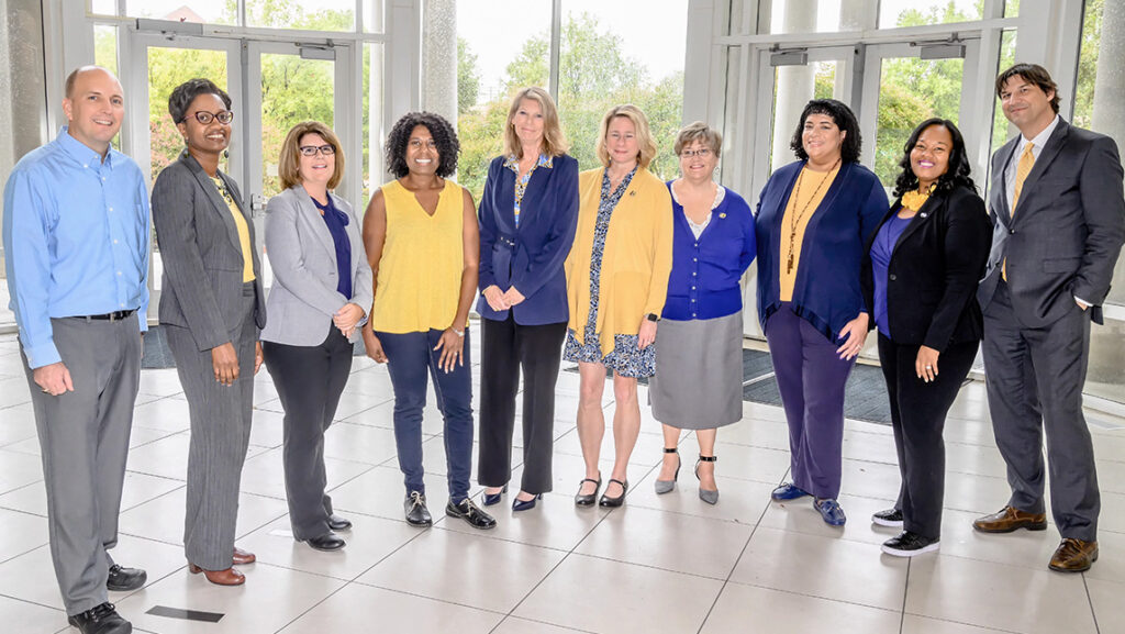 Group photo of UNCG faculty and staff in the MHRA building