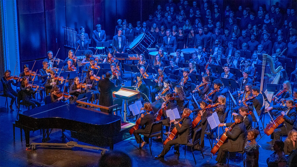 Musicians in an orchestra performing.