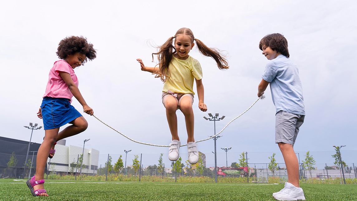 Three children playing jump-rope
