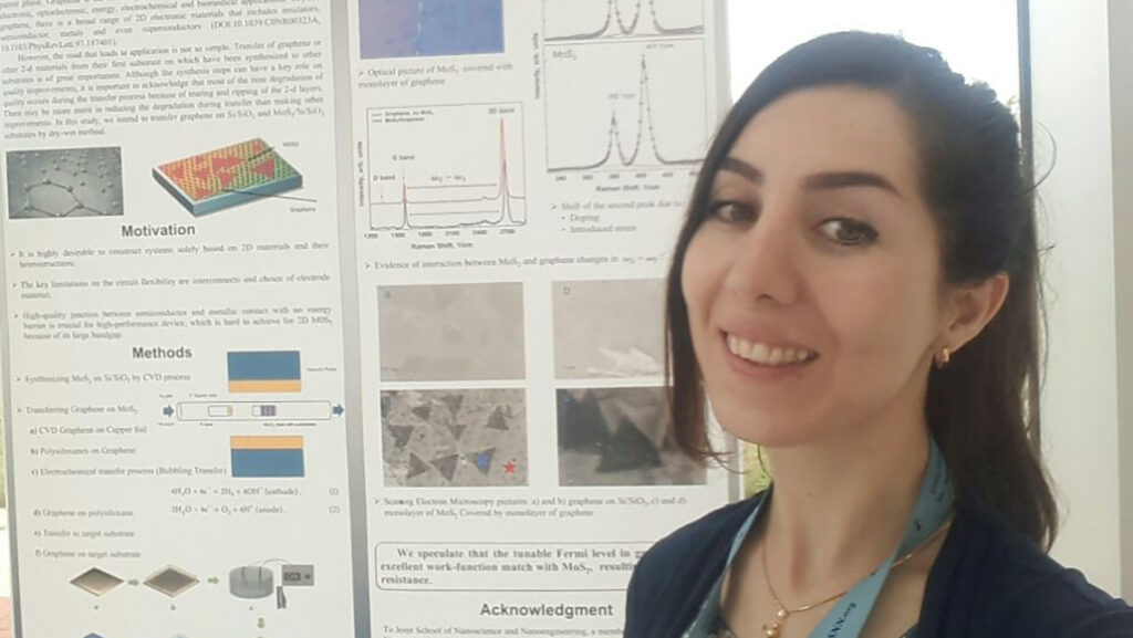 Woman smiling in front of research board