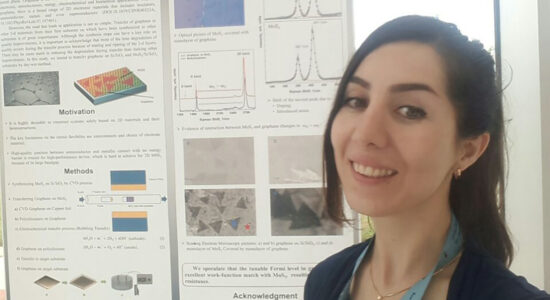 Woman smiling in front of research board