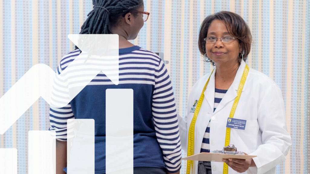 Stephanie Pickett wearing labcoat with student wearing blue in back of white arrow and graph