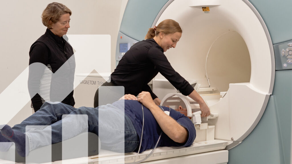 Patient being placed in MRI with white arrow and bar graph in corner