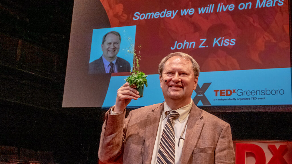 John Z. Kiss on the stage of TedX Greensboro for his presentation "Someday we will live on Mars"