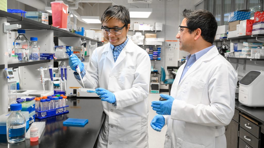 Beh Reh and mentor Ramji Bhandari work in the lab