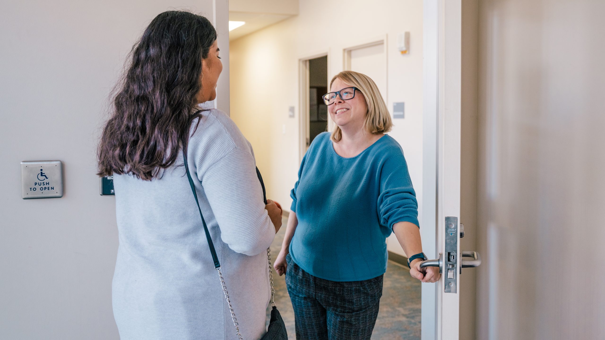 Center for New North Carolinians Besty Jenson speaks to someone in their immigration services office