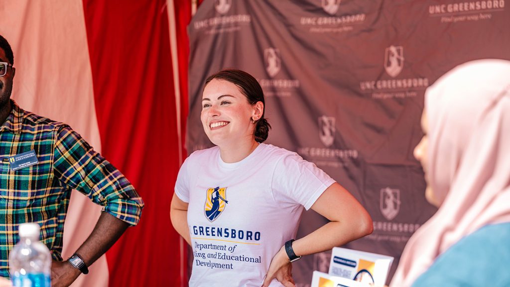 Alex Cammarano smiles with hands on her hips