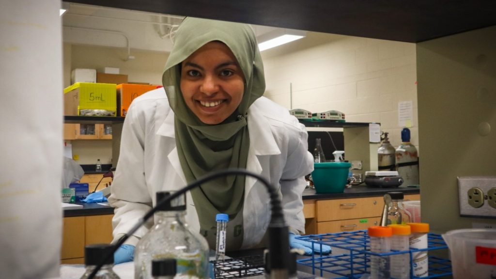 Fatima Elhorry smiles and peers through a cabinet