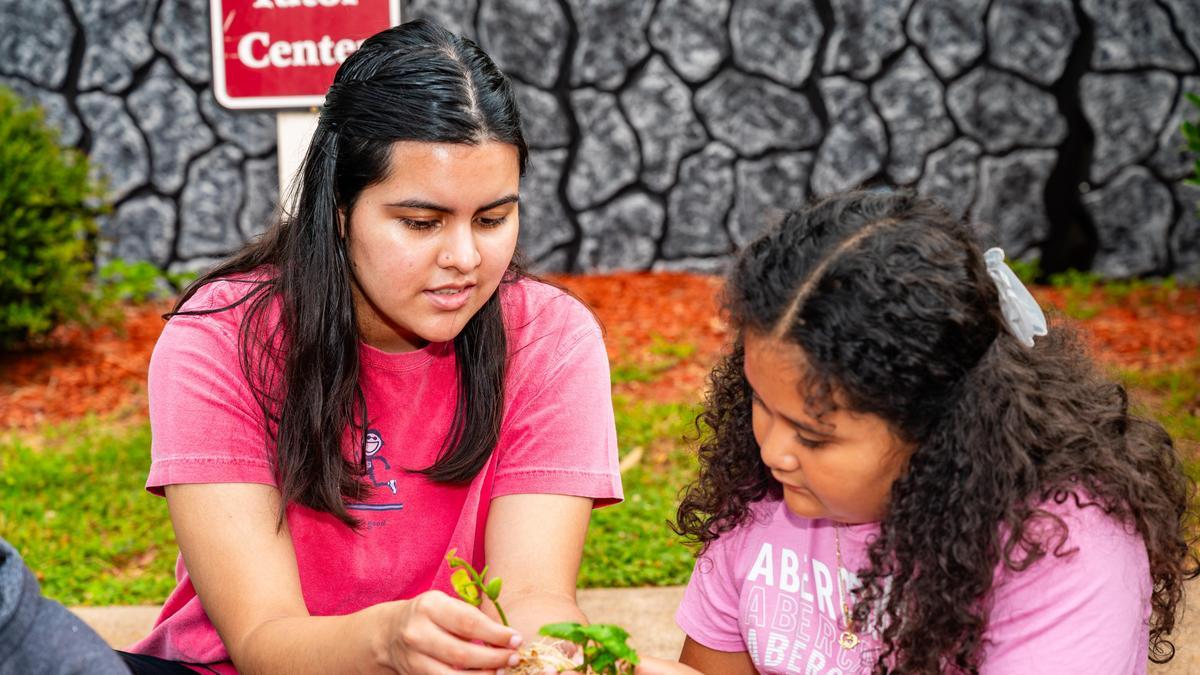Kids and camp counselors work for a summer camp sponsored by CNNC