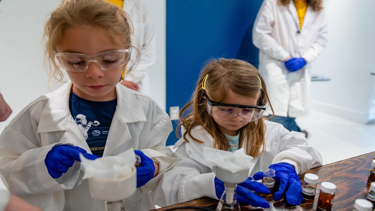 Photos of families engaging with UNCG staff and volunteers in various activities across campus during Science Everywhere 2023.