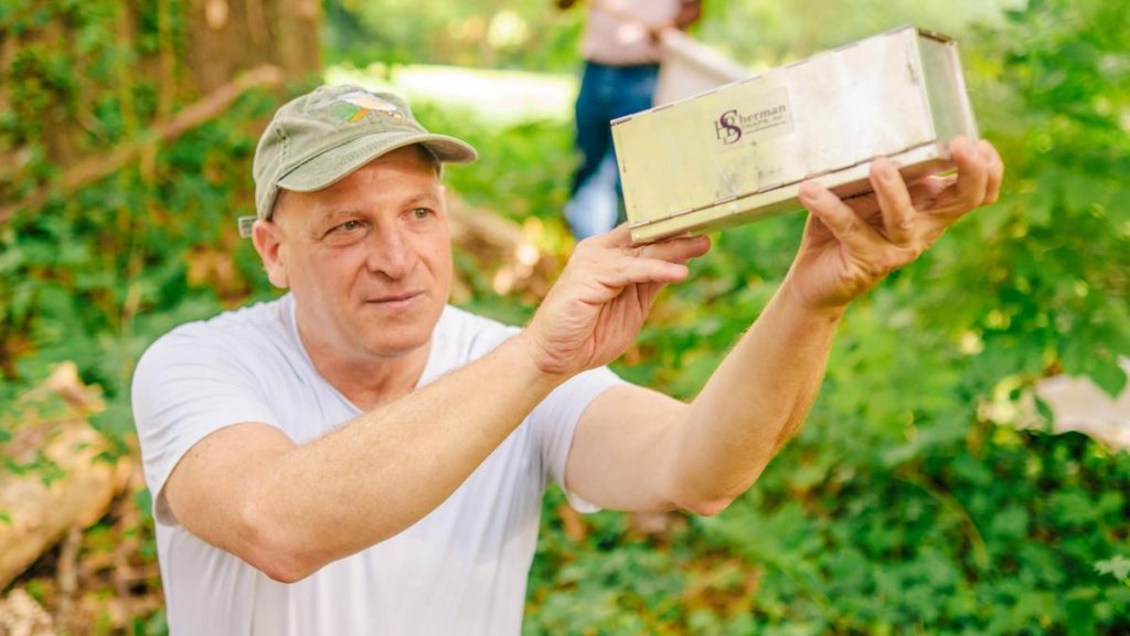 Dr. Gideon Wasserberg holds a box up and looks inside.